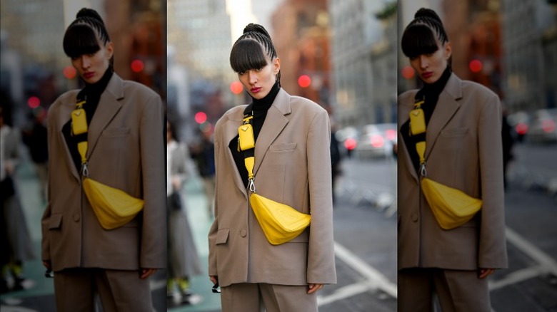 Woman wearing black turtleneck under tan blazer