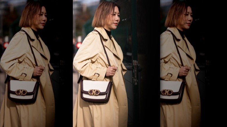 Woman in black turtleneck with trench coat