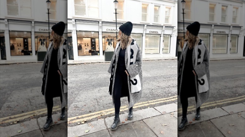 woman wearing coat and logo scarf