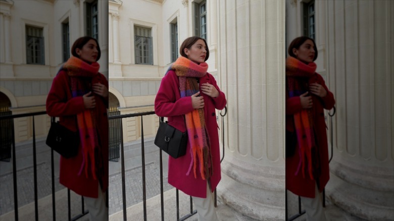 woman wearing pink coat and plaid scarf