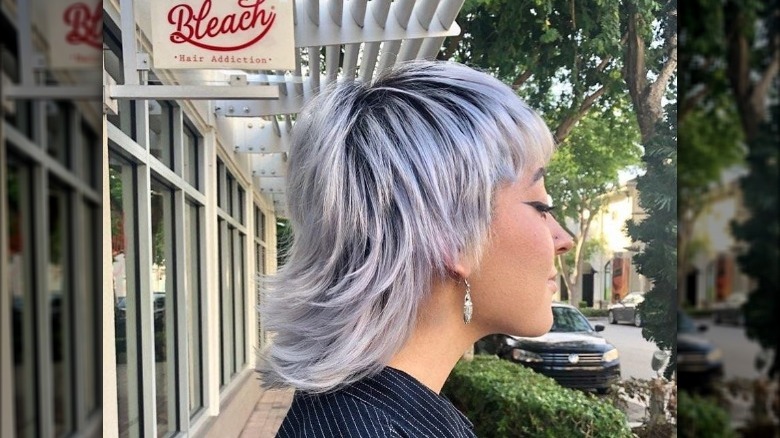 Girl with a wixie that is longer in the back.