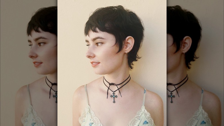 Girl wearing a wavy wixie cut.