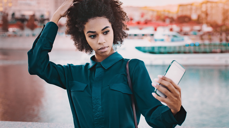 Girl taking selfie in teal outfit