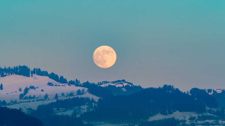 full moon over snowy landscape