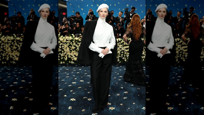 Hunter Schafer at the 2025 Met Gala in a black and white outfit with a beret