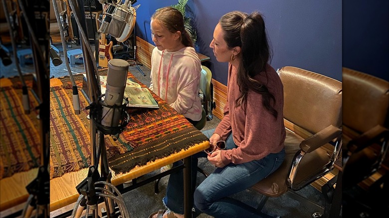 Joanna Gaines with her child reading from a book