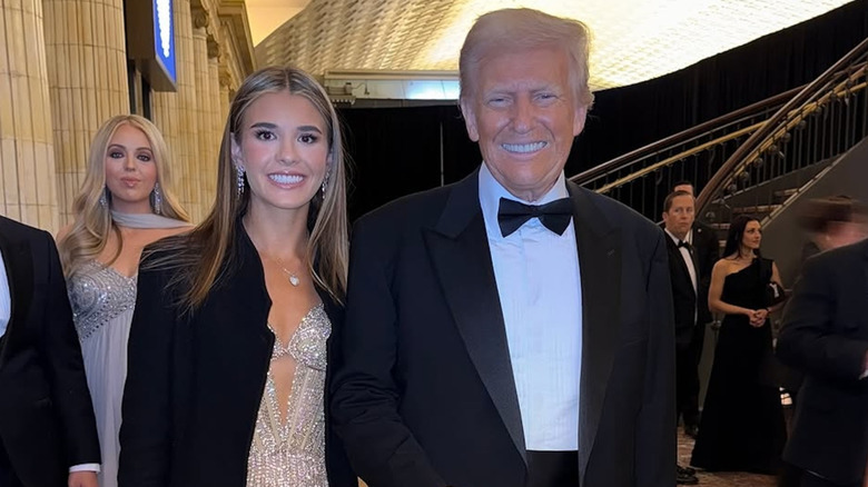 Kai Trump poses with her grandfather, President Donald Trump