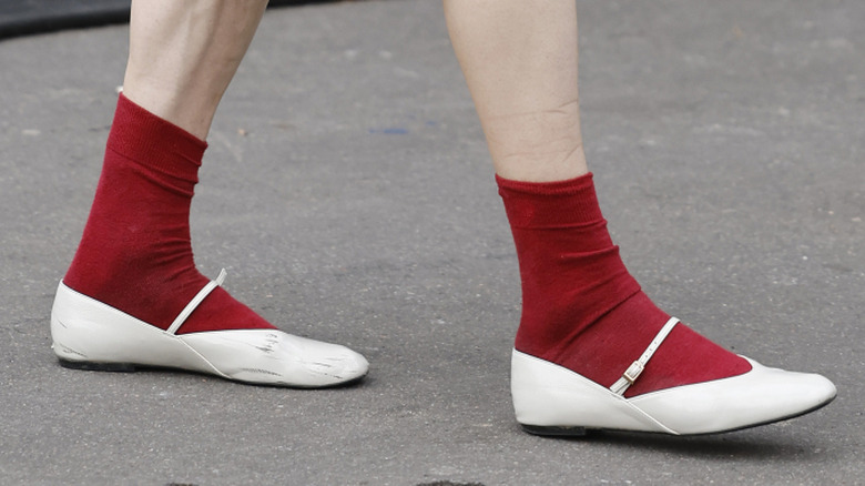 White almond-toe flats with a Mary-Jane strap.