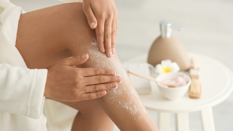 Woman using a scrub on legs