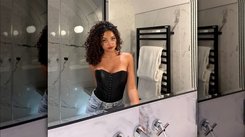 A woman wearing a black corset