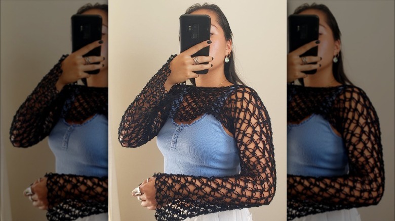 A woman wearing a crochet mesh top