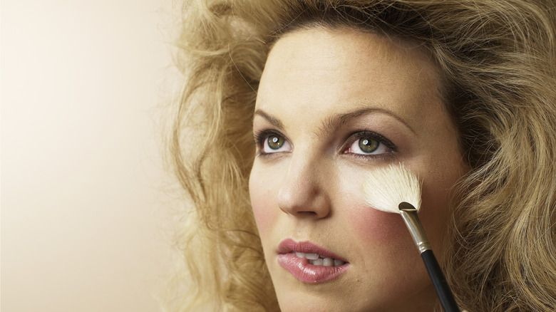 Woman applying too much highlighter