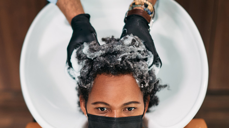 Woman washing hair at salon