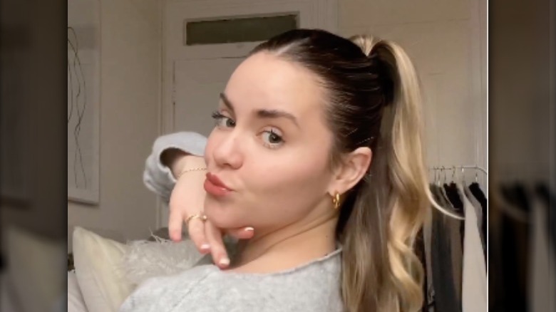 Woman with middle part and half ponytail