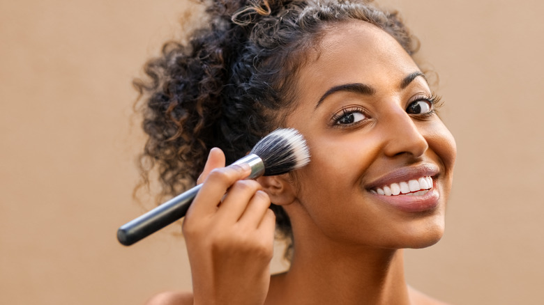 person using a makeup brush