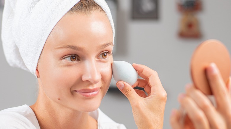 Woman blending out concealer