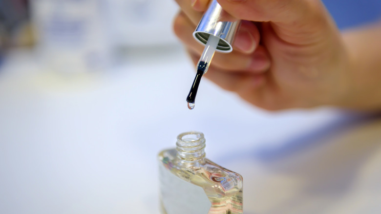 Person using clear nail polish