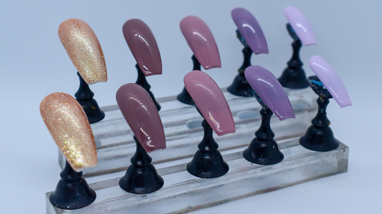 Set of multicolored press-on nails on stands