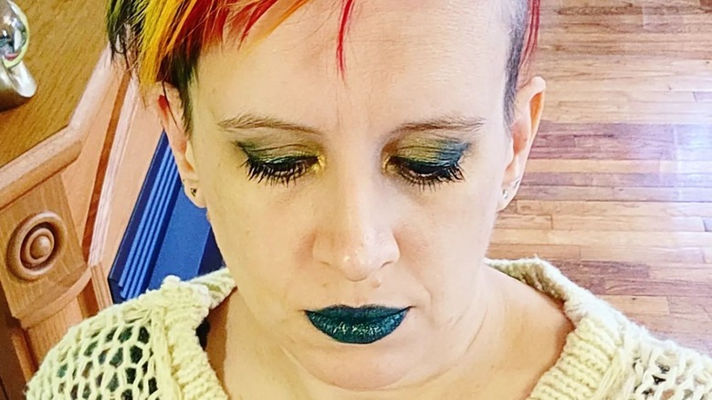 Shiny dark teal lipstick