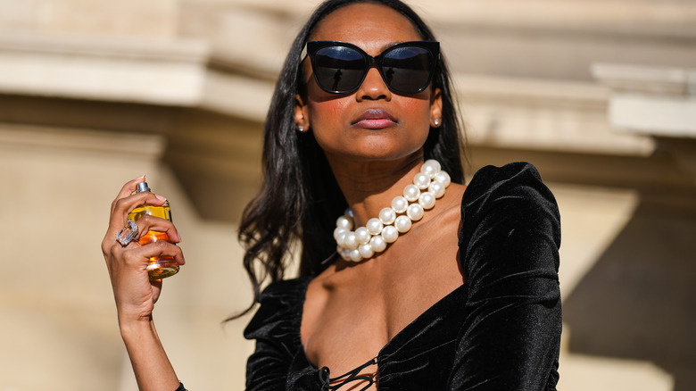 Girl wearing extra large pearl necklace.