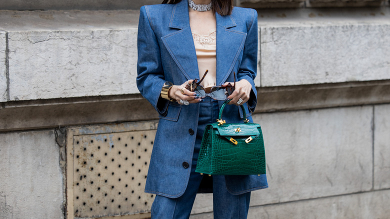 A woman wearing a denim coat with denim trousers