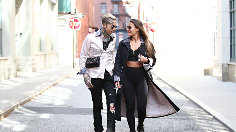 Woman and man walking in an alley