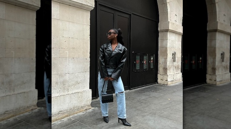 woman wearing leather jacket and denim jeans