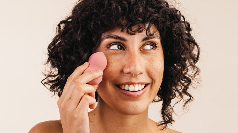 woman using a beauty blender