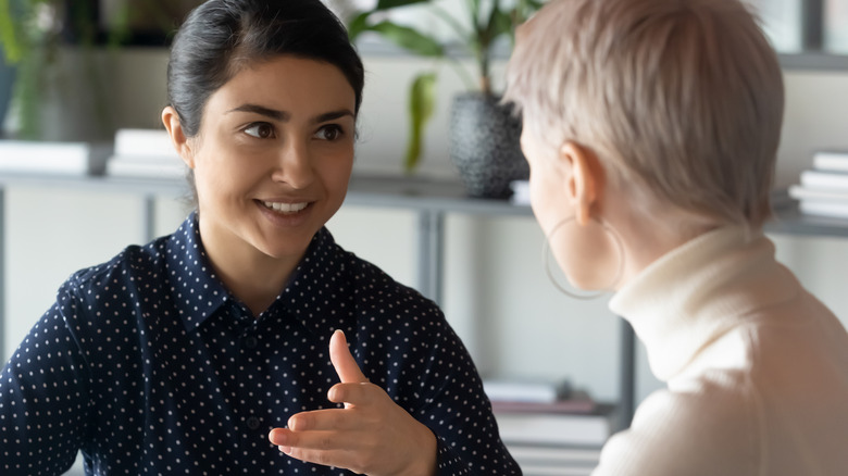 Smiling woman explaining idea