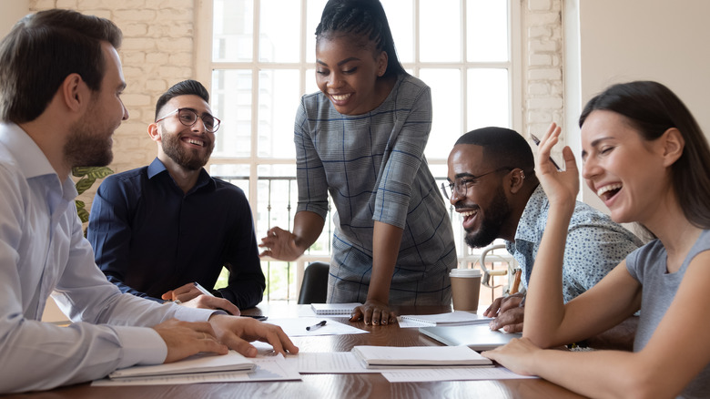 Colleagues laughing in business meeting