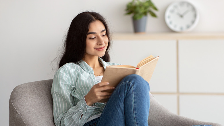 Women sitting down and reading book 