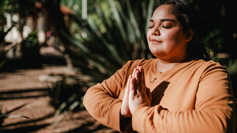 Woman meditating outside