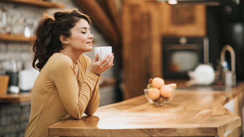 woman smelling coffee