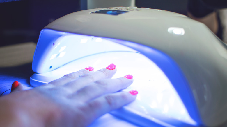 woman curing gel nails
