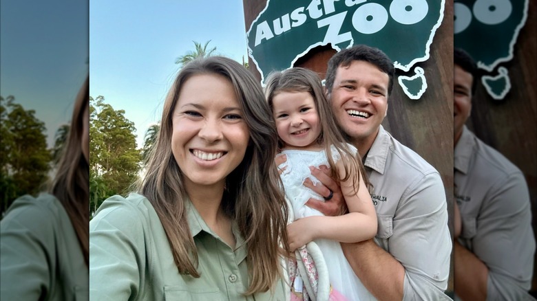 Bindi Irwin smiles next to daughter, Grace, and husband, Chandler Powell