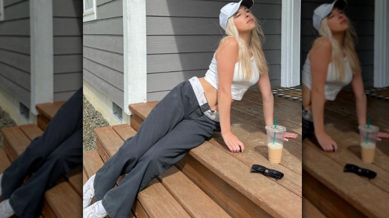 Woman wearing pants, sitting on steps