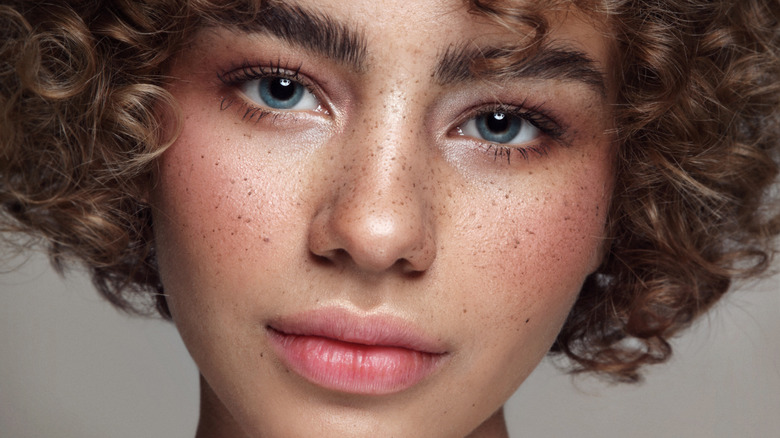 Woman freckles curly hair
