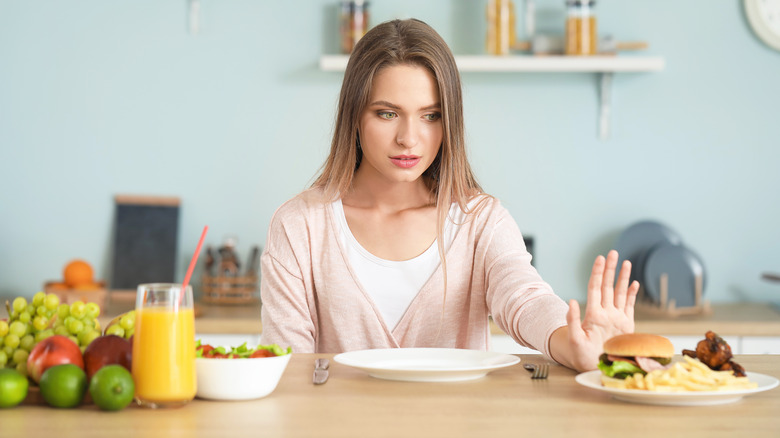 woman pushing away food