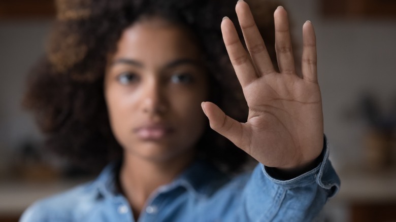 Woman holding hand up