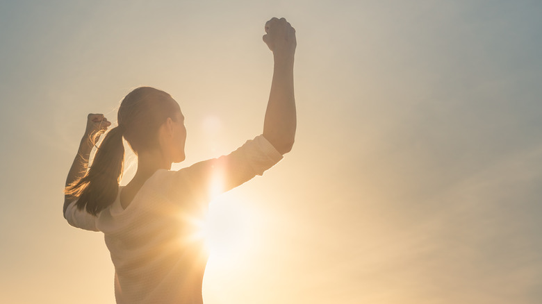 person raising arms up  