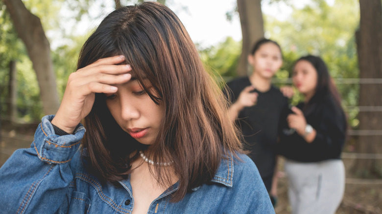 person hiding from two people behind them