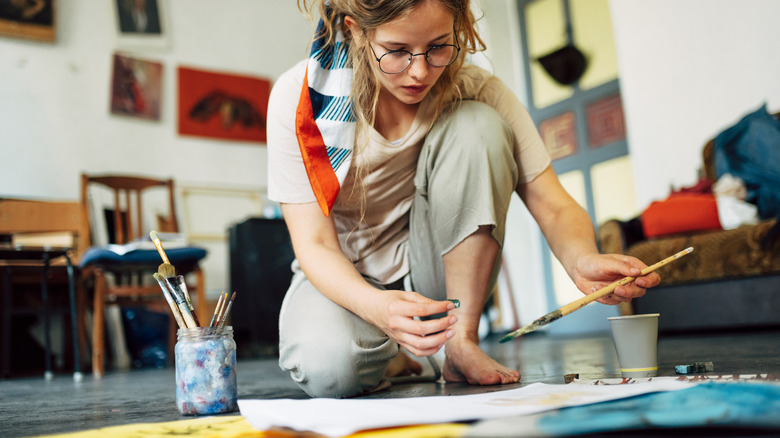 person painting on floor
