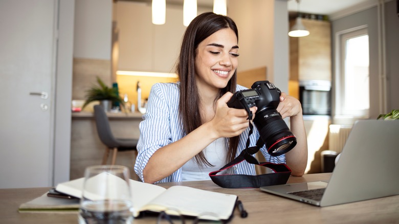 person holding digital camera