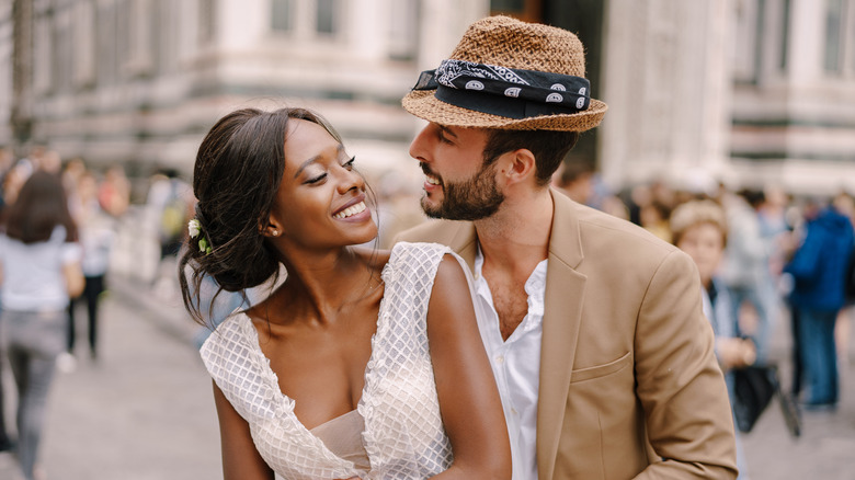 Smiling couple posing on street