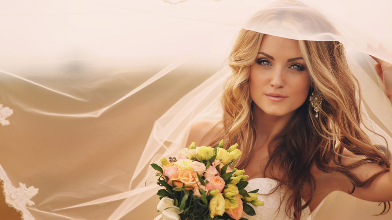 Blonde bride wearing wedding veil