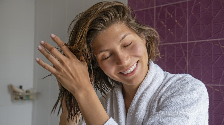 woman applying cream in hair