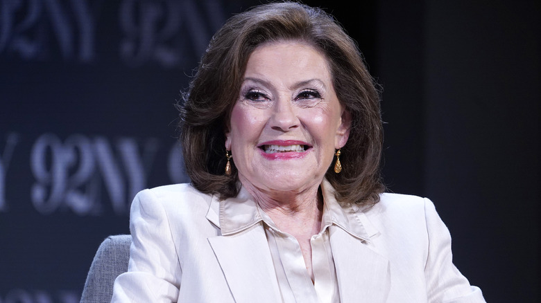 Kelly Bishop smiling while wearing a white suit in 2025
