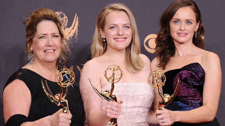 Ann Dowd, Elizabeth Moss, and Alexis Bledel holding award