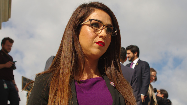 Lauren Boebert wearing a blazer and glasses, looking unhappy