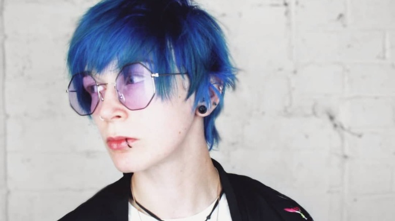 Person wearing geometric lavender sunglasses